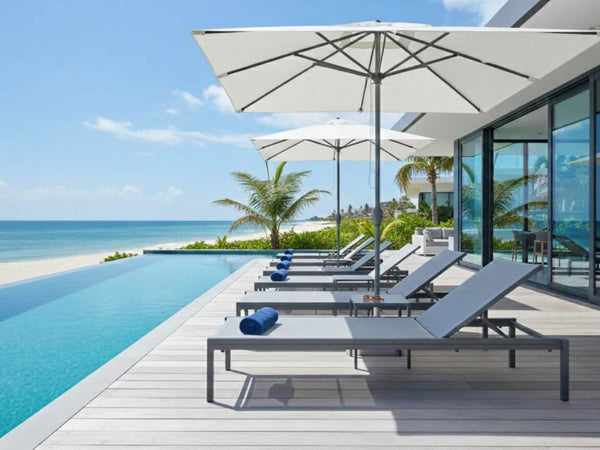 Riva Sun Lounger with powder coated aluminium frame and charcoal UV stabilised sling fabric by poolside