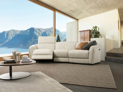 Royale 3 Seater Curved Recliner Sofa in living room, featuring elegant curved design and white upholstery.