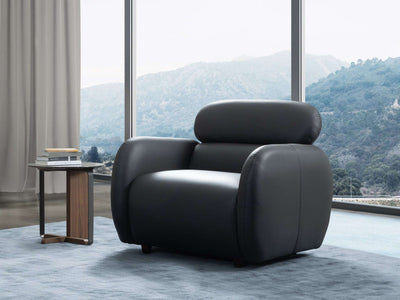 Sequence Leather Armchair in modern living room setting with mountain view.
