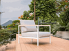 Sierra Outdoor Lounge - 1 Seater Sofa with aluminum frame and teak arm trim on a deck.