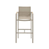 Sierra Outdoor Sling Bar Chair with sand powder-coated aluminium frame, nutmeg sling fabric, and teak armrest trim.