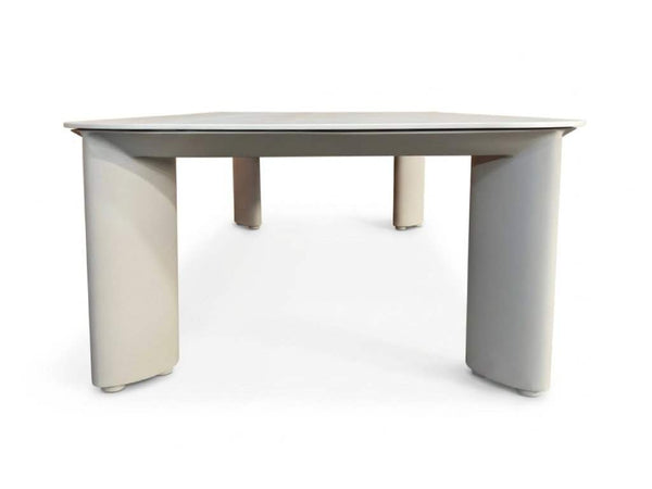 Sierra Outdoor Ceramic Coffee Table with a light grey ceramic top and matching curved aluminium frame legs