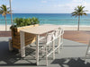 Sierra Outdoor Bar Table with 6mm ceramic travertine top and white powder-coated aluminum frame on beach deck