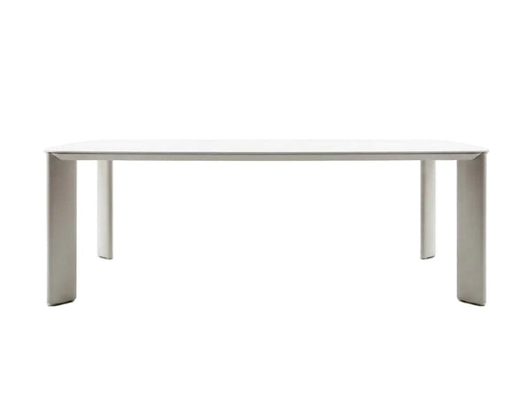 Sierra Outdoor Ceramic Dining Table with a smooth travertine-coloured 6mm ceramic top and sand-coloured frame legs