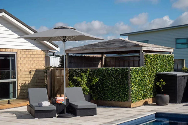 SU2 Café & Resort Outdoor Umbrella shading poolside lounge chairs in modern backyard