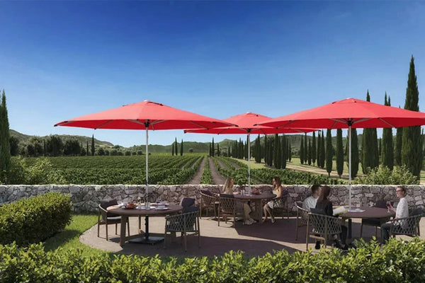 SU2 Café & Resort Outdoor Umbrella providing stylish shade over outdoor dining tables in a vineyard setting