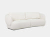 Sussex 3.5 seater curved sofa in white with soft, rounded cushions and sculptural design