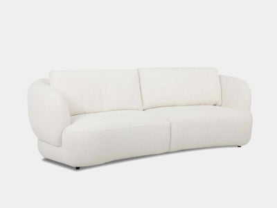 Sussex 3.5 seater curved sofa in white with soft, rounded cushions and sculptural design