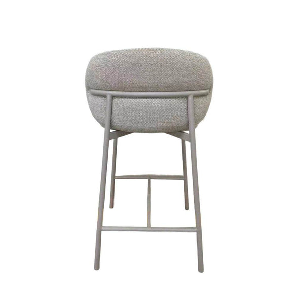 Theo Bar Chair with matte light grey steel frame and ecru fabric upholstery, featuring integrated footrest and minimalist design