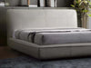 Todd Bed Frame with curved edges and upholstered silhouette in a modern bedroom setting.