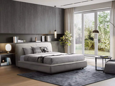 Todd Bed Frame in a modern bedroom with soft, upholstered design and elegant curves, complemented by neutral decor and large windows.