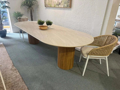 Toledo Ceramic Outdoor Dining Table with oval ceramic top and solid teak cylinder bases in modern outdoor setting