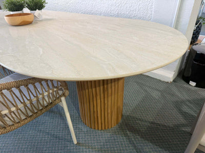 Toledo Ceramic Outdoor Dining Table with oval ceramic top and solid teak cylindrical base in modern outdoor setting