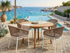 Tribu Outdoor Teak Round Dining Table on patio with natural wood finish and round design