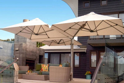 Unity Multi-Canopy Cantilever Outdoor Umbrella with beige canopies and marine-grade aluminum frame providing shade over outdoor seating area