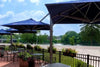 Unity Multi-Canopy Cantilever Outdoor Umbrella providing shaded outdoor seating with navy blue Sunbrella fabric canopies and durable marine-grade aluminum frame.