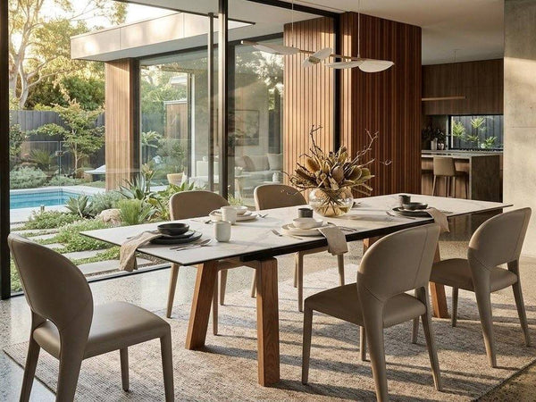 Alfie Leather Dining Chair - Fully Upholstered in taupe leather, with a smooth finish, curved back and tapered legs.